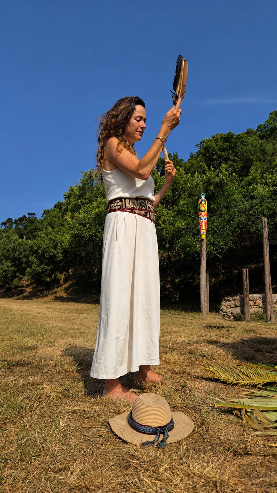 Galya holding a feather during ceremony